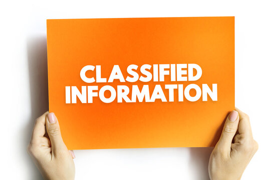 CLASSIFIED INFORMATION text on card held by hands. Confidential data security concept emphasizing privacy, restricted access, and protection of secret organizational details