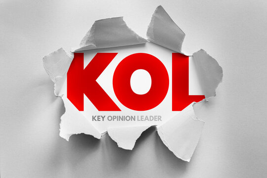 KOL stands for key opinion leader. Acronym revealed behind torn paper. Influencer marketing concept involving experts, authorities, and thought leaders who shape public perception and trends