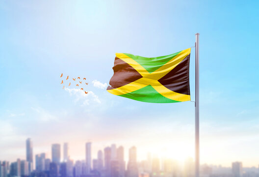 Jamaica national flag waving with skyline and buildings. Jamaica national flag for independence day.