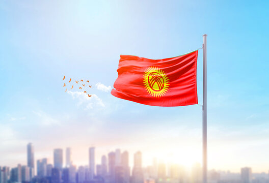 Kyrgyzstan national flag waving with skyline and buildings. Kyrgyzstan national flag for independence day.