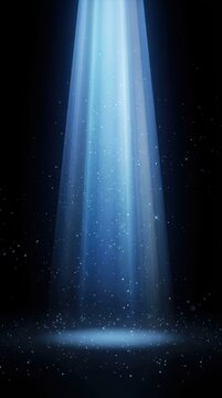 Blue spotlight beam illuminating dust particles on dark floor with abstract concept