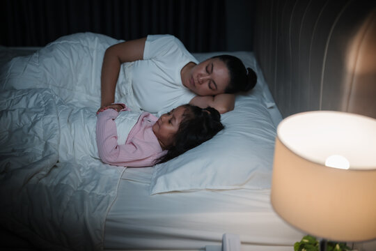 mother and daughter sleeping together and sweet dream in bed at night&nbsp;