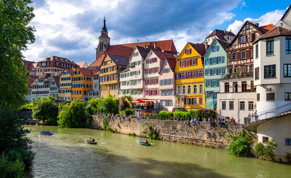 Scenic view from Eberhardsbr&uuml;cke across the Neckar River to T&uuml;bingen&rsquo;s colorful historic waterfront, with traditional houses, church tower, boats and riverside promenade.