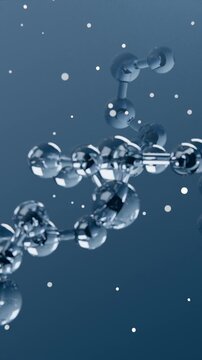 Vertical video: Pulling camera revealing chrome spheres and rods in calm blue space, showing depth