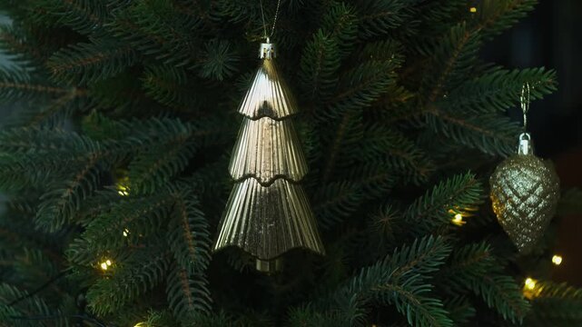 Woman decorating Christmas tree with Christmas bauble.