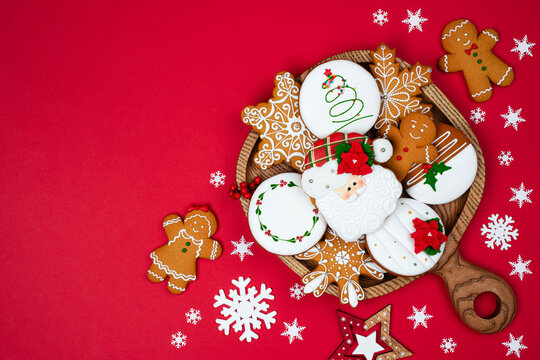 Christmas cookies and gingerbread on red background with copy space
