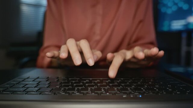 Young adult woman hands typing rapidly on laptop keyboard during coding session. Footage suitable for cybersecurity marketing, data protection concepts, and software development projects