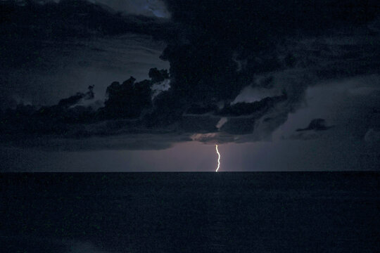 Lightning flashes and storm clouds over the sea