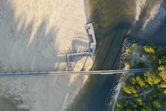 Downward aerial view of Back Creek Bridge crossing the sandy tidal creek and clear coastal water at South West Rocks, New South Wales, Australia.