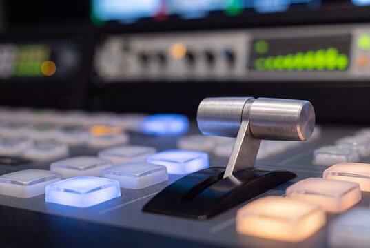 Close up of metal fader lever on modern video production switcher