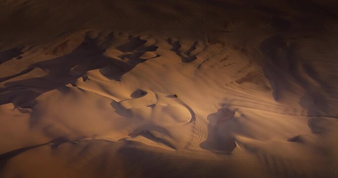 Sunset drone view of dune buggy tour in desert dunes of Huacachina, Peru