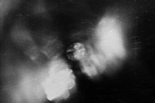 Dusty scratched and scanned old film texture, light leaks overlay effect. Retro analog cinematic flare.