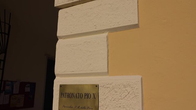 Plaque on the side of a building. Bassano del Grappa, Vicenza province, Veneto, northern Italy.