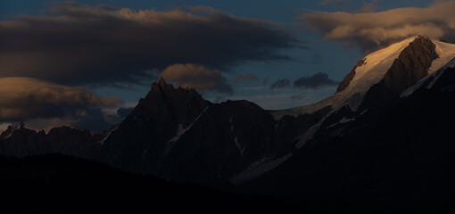 Obraz premium Summer view of the Mont Blanc massif above forested slopes 