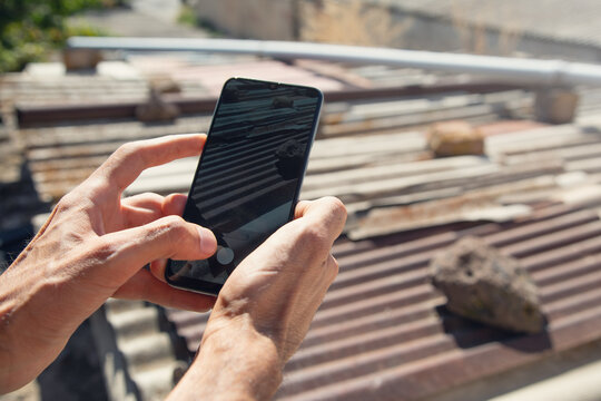 Man taking picture old asbestos pieces. Health problems