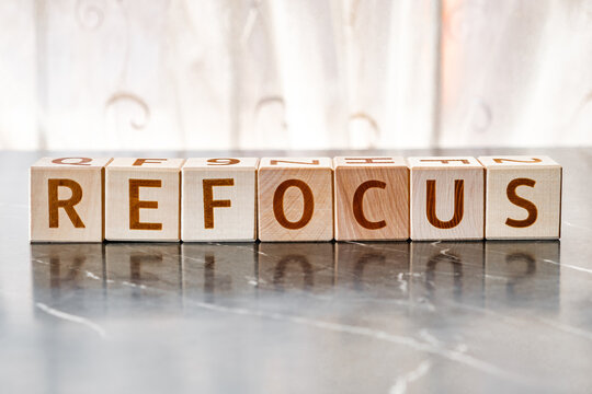motivational word Refocus, from letters on wooden cubes