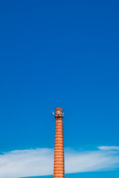 brick industrial chimney on background of sky