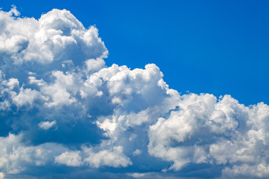 white cumulus clouds in blue sky background