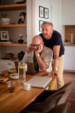 Gay couple working from home