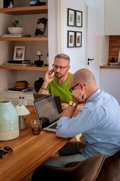 Gay couple working from home