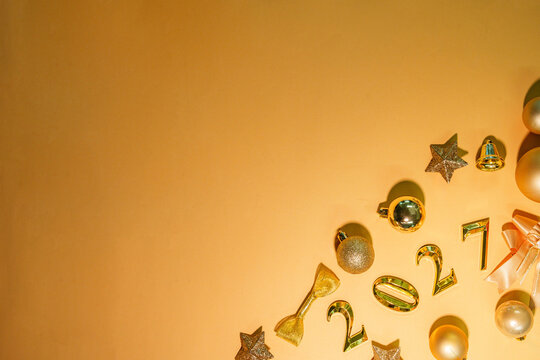 2027 New Year flat lay background with golden decorations and copy space