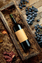 Obraz premium Bottle of red wine in an antique wooden box.