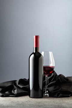 Bottle and glass of red wine.