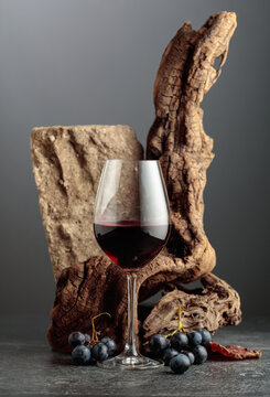 Red wine with stone, dried snags, and blue grapes.