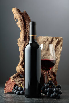 Red wine with stone, dried snags, and blue grapes.
