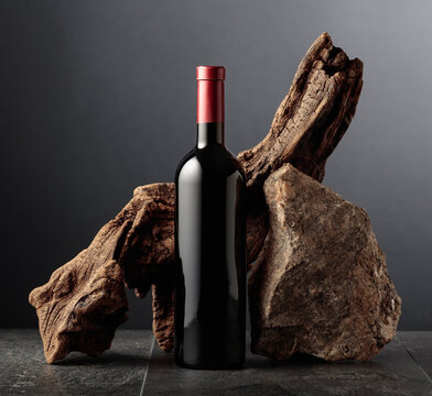 Red wine with old snag and a piece of granite rock.