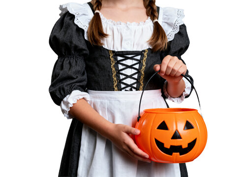 Halloween, young person in dark historic maid's costume with white ruffles, holding an orange jack-o'-lantern bucket, isolated for seasonal designs.