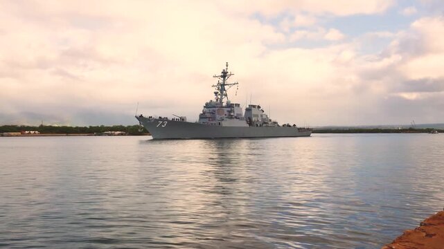 Arleigh Burke Class Guided Missile Destroyer DDG 73 USS Decatur Departs on a Quiet Sea at Sunset.