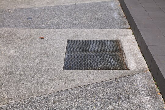Street cellar access. Diamont plate two piece door in a street in Singapore city.