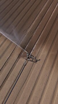 Overhead Irrigation Reel Watering Vegetable Crops on Italian Farmland