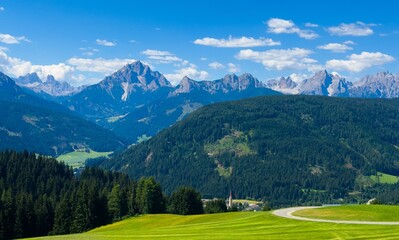 Obraz premium Majestic scenery of rough mountain ridge near grassy hills 