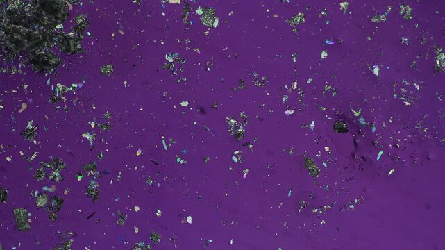 Calm crystal drift turning into sudden stormy turbulent fluid flow with chaotic movement under polarized light microscope realtime footage for laboratory hydrodynamics and chemical science asset