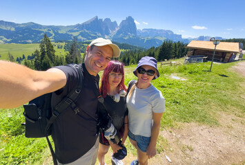 Obraz premium family, hiking and mountain on cliff outdoor for fitness travel, adventure view and backpack journey. People, backpacking and trekking together for cardio exercise, rock climbing and health in summer