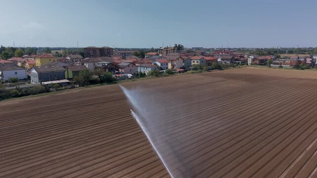Irrigation Reel Watering Crops in Agricultural Field in Lombardy Italy