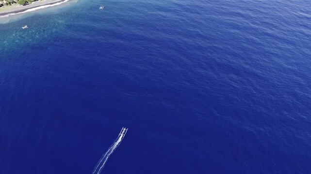 Traditional balinese jukung boat sailing in amed
