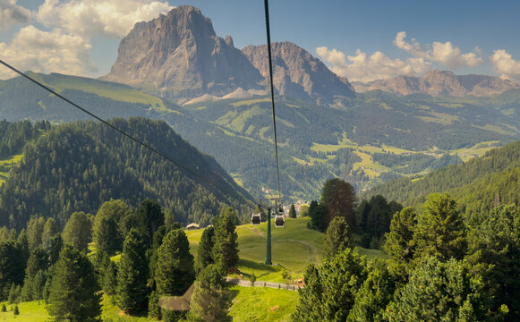 Aerial view from cable car gondola over Alpine valley and pine forest, Seceda, Val Gardena, Dolomites, Italy Stock Photo