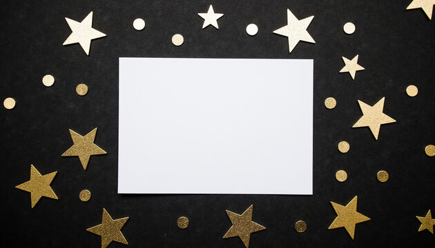 Top view flat lay of blank white card mock up surrounded by golden glitter stars and confetti dots on black background, greeting card copy space.