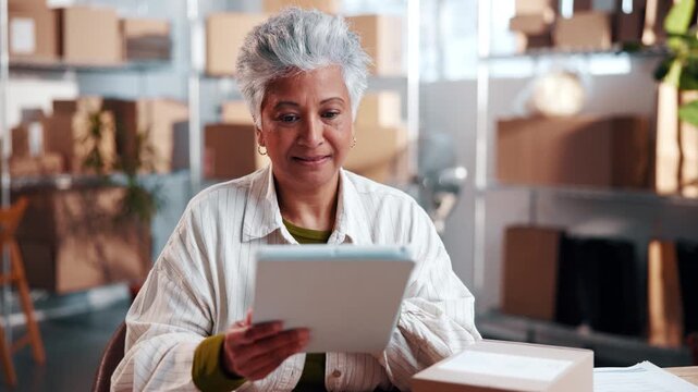 Smile, woman and tablet with boxes for ecommerce, research and confirm order for stock control. Mature person, startup and review in office with tech, inventory availability and catalog for delivery