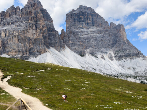 panorama of Tre Cime in the Dolomites, highlighting jagged cliffs and green meadows 