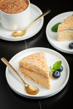 Medovik. Honey cake made from honey cakes with whipped sour cream, decorated with berries, pomegranate and flowers
