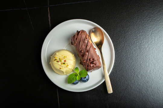 Delicious glazed curd snacks with fresh blueberries and mint on light grey table, closeup