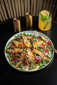 Salad with Pear, Arugula, Jamon, Blue Cheese and Blueberry, Delicious Fresh Salad Appetizer on Bright Background