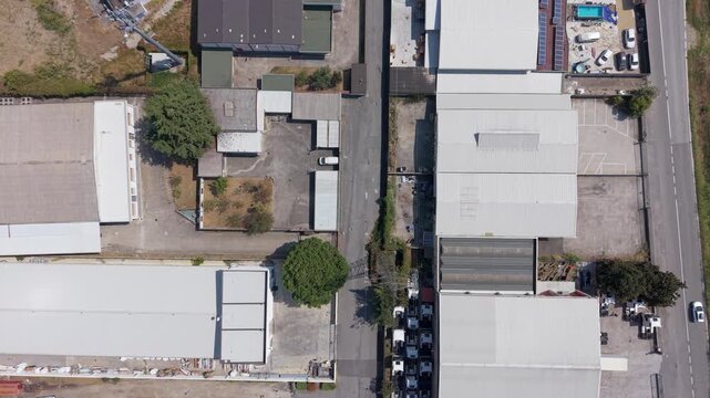 Aerial perspective of extensive warehouse facilities and transport infrastructure within an industrial area of Lombardy.