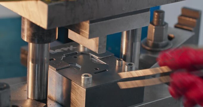 Metal component production with bending die and mechanical stamping press. Close-up of industrial tooling during sheet metal forming