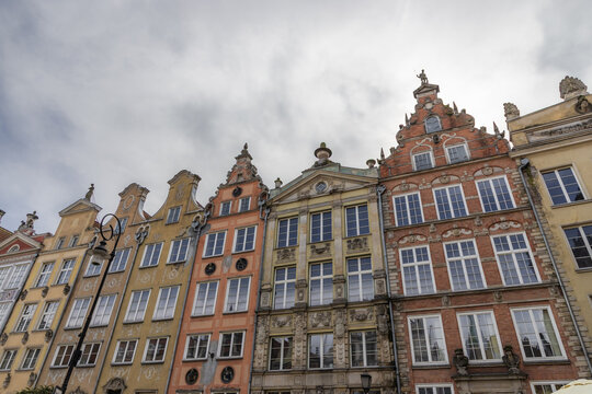 Gdansk, Poland - 05 September 2026: View of historic colorful tenement houses with ornate facades and gabled roofs under a cloudy sky in the old town.
