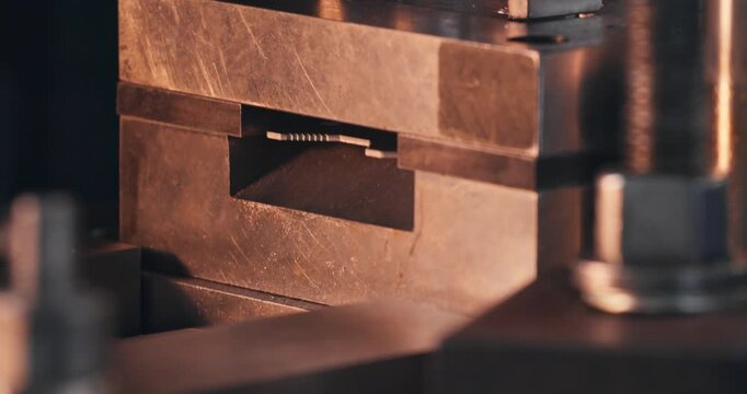 Metal blanking on mechanical punch press, close-up. Working stamping die in industrial component manufacturing